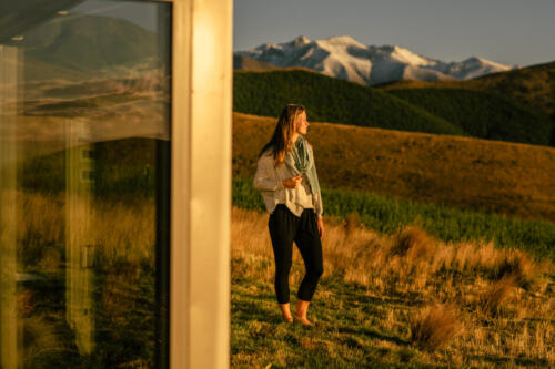 Woman outside, mountains in back ground 